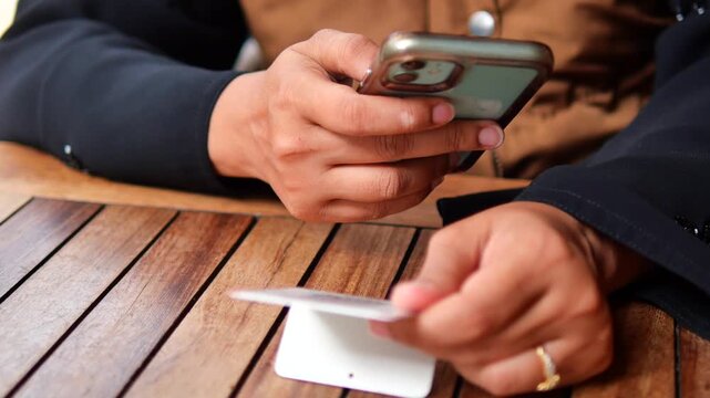woman using smart phone to scan the QR code to find the menu 
