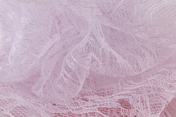 Elegant beautiful waves of transparent guipure fabric in white with a floral pattern. airy fabric material. Wedding concept. tulle