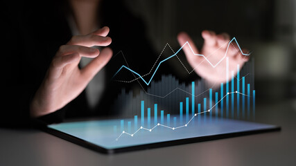 A business professional uses a tablet to interact with vibrant graphs and charts, showcasing data analysis and financial trends in a modern workspace. Scalp