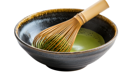 Traditional bamboo whisk resting in a dark ceramic bowl filled with vibrant green matcha tea powder on transparent background