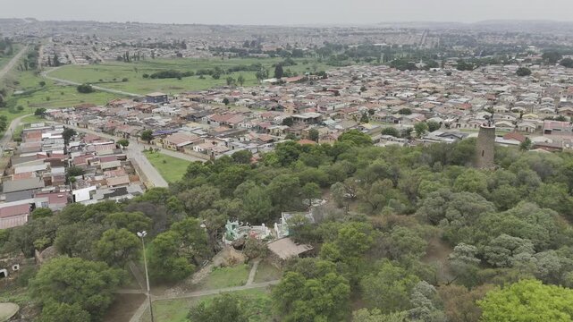 Drone flies forward as it descends on Credo Mutwa Cultural Village, Soweto, South Africa