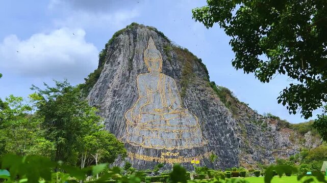 CHONBURI, Thailand - June 9, 2025: The Golden Buddha Mountain. The Buddha image carved into the rock of Khao Chi Chan, Khao Chion, Pattaya, engraved in gold,on a hill dedicated to His Majesty the King