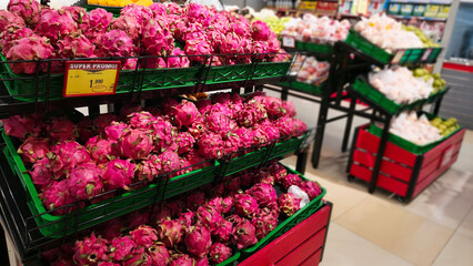 Pile of fresh dragon fruit on the supermarket sales display shelf