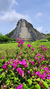 CHONBURI, Thailand - June 9, 2025: The Golden Buddha Mountain. The Buddha image carved into the rock of Khao Chi Chan, Khao Chion, Pattaya, engraved in gold,on a hill dedicated to His Majesty the King