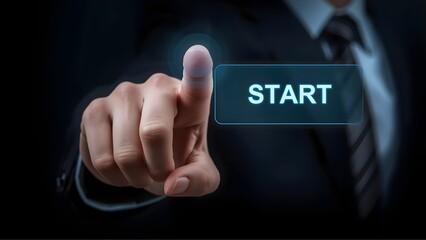 Business hand pressing digital start button to begin process on dark background