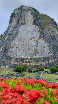 CHONBURI, Thailand - June 9, 2025: The Golden Buddha Mountain. The Buddha image carved into the rock of Khao Chi Chan, Khao Chion, Pattaya, engraved in gold,on a hill dedicated to His Majesty the King