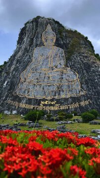 CHONBURI, Thailand - June 9, 2025: The Golden Buddha Mountain. The Buddha image carved into the rock of Khao Chi Chan, Khao Chion, Pattaya, engraved in gold,on a hill dedicated to His Majesty the King