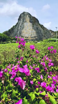 CHONBURI, Thailand - June 9, 2025: The Golden Buddha Mountain. The Buddha image carved into the rock of Khao Chi Chan, Khao Chion, Pattaya, engraved in gold,on a hill dedicated to His Majesty the King