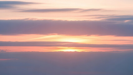Fototapeta premium Pastel Sunset Sky with Orange and Pink Hues, Clouds and Sunrays Above Distant Mountains. Serene Natural Light.