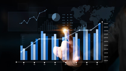 Business professional interacts with modern touchscreen interface displaying various graphs and charts, highlighting data analysis and performance metrics for strategic decision-making. Scalp