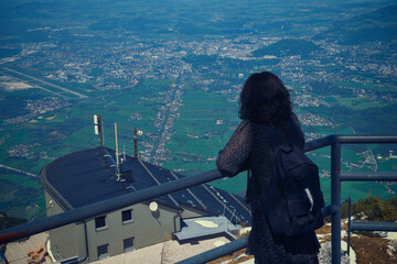 A woman looking out over Salzburg city from a mountain viewpoint, Austria, April 27, 2025