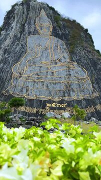 CHONBURI, Thailand - June 9, 2025: The Golden Buddha Mountain. The Buddha image carved into the rock of Khao Chi Chan, Khao Chion, Pattaya, engraved in gold,on a hill dedicated to His Majesty the King