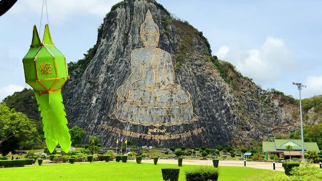 CHONBURI, Thailand - June 9, 2025: The Golden Buddha Mountain. The Buddha image carved into the rock of Khao Chi Chan, Khao Chion, Pattaya, engraved in gold,on a hill dedicated to His Majesty the King