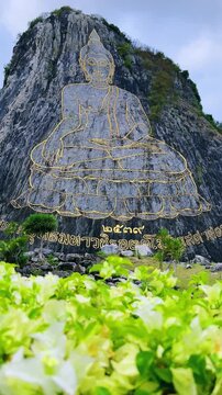 CHONBURI, Thailand - June 9, 2025: The Golden Buddha Mountain. The Buddha image carved into the rock of Khao Chi Chan, Khao Chion, Pattaya, engraved in gold,on a hill dedicated to His Majesty the King