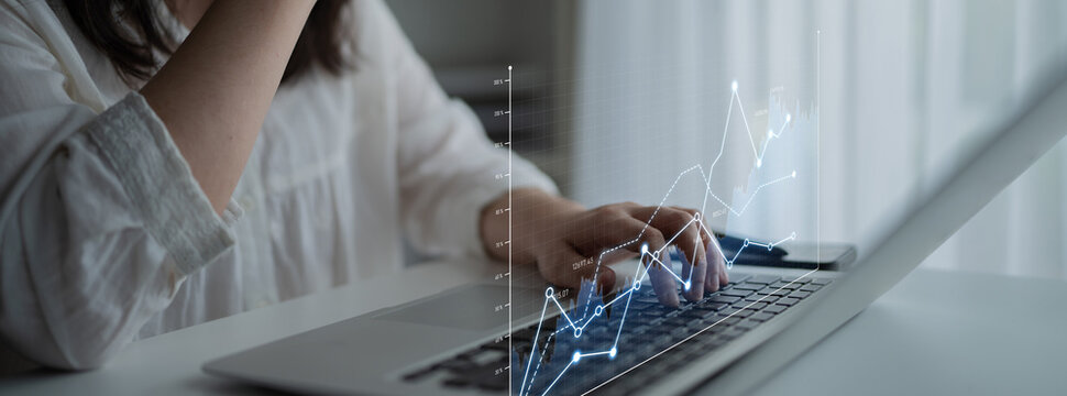 A business professional engages in data analysis on a laptop. The image features a digital graphical interface overlay, representing modern analytics in a professional workspace. Scalp - Powered by Adobe