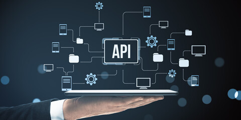 API integration network concept on digital tablet with connected device icons and data flow symbols on dark abstract background.