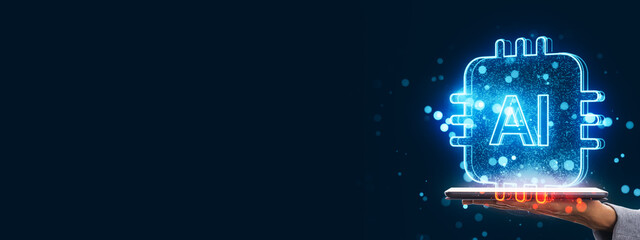 Futuristic glowing AI chip symbol hovering over a tablet held by a hand on dark background with digital particles and copy space on left side.