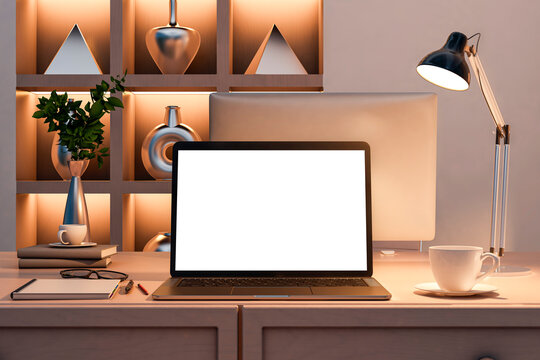 Modern home office desk with laptop mockup screen, coffee cup, and lamp in cozy evening interior lighting against bookshelves background. 3D Rendering