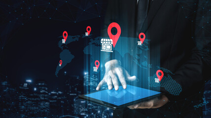 A professional man interacts with a tablet showcasing location markers around a world map, symbolizing business strategy and global connectivity in a digital era. Gantry
