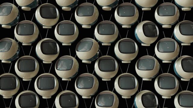 3D rendered animation of a random array of vintage futurism sphere-shaped 1970s televisions with blank screens rotating on an isolated background
