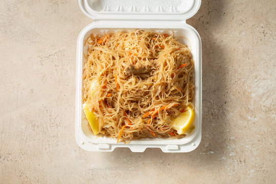 A top down view of a container of pancit bihon.