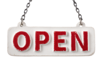 Sign hanging from chain shows the word open in red letters against a white background in a business setting during the day