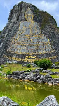 CHONBURI, Thailand - June 9, 2025: The Golden Buddha Mountain. The Buddha image carved into the rock of Khao Chi Chan, Khao Chion, Pattaya, engraved in gold,on a hill dedicated to His Majesty the King