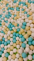 A vibrant, colorful pile of small, round balls in shades of white, blue, and yellow, suggesting a fun and playful environment