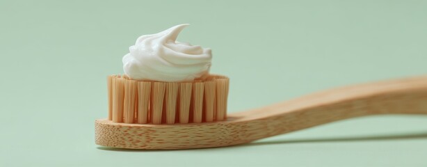 The Bamboo Toothbrush with Whipped Toothpaste Swirl on Minimal Mint Background