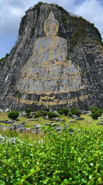CHONBURI, Thailand - June 9, 2025: The Golden Buddha Mountain. The Buddha image carved into the rock of Khao Chi Chan, Khao Chion, Pattaya, engraved in gold,on a hill dedicated to His Majesty the King