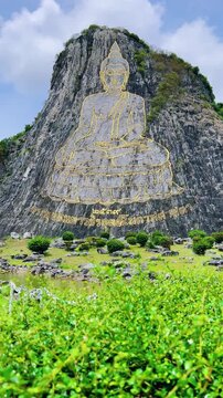 CHONBURI, Thailand - June 9, 2025: The Golden Buddha Mountain. The Buddha image carved into the rock of Khao Chi Chan, Khao Chion, Pattaya, engraved in gold,on a hill dedicated to His Majesty the King