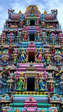 Kuala Lumpur, Malaysia - June 18, 2025: Close-up and facade of the Hindu temple Sri Maha Mariamman Dhevasthanam with prayer flags and sculptures of deities, in Chinatown. 4К