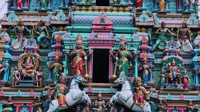 Kuala Lumpur, Malaysia - June 18, 2025: Close-up and facade of the Hindu temple Sri Maha Mariamman Dhevasthanam with prayer flags and sculptures of deities, in Chinatown. 4К