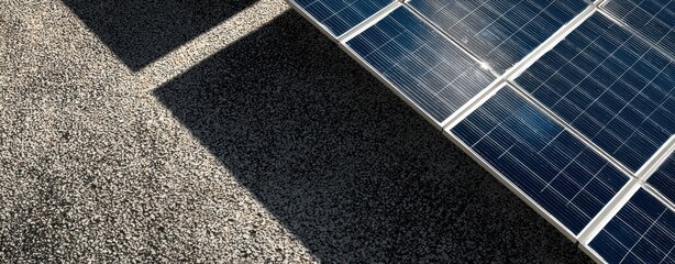 The Solar Panel on Rooftop Casting Shadow Over Gravel Surface in Sunlight
