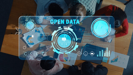 A vibrant collaborative workspace showcases a digital open data interface while a diverse group of professionals engages in analyzing strategies and information trends. Trope