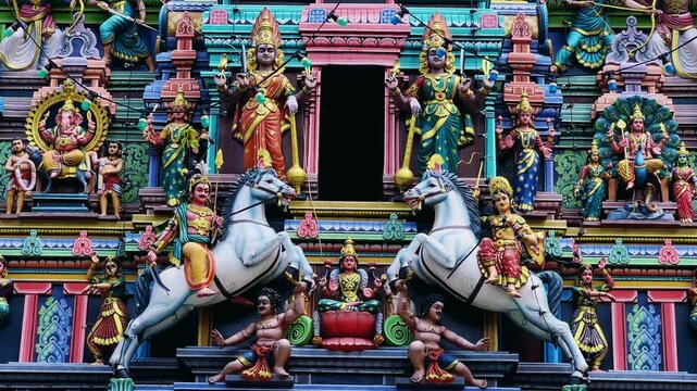 Kuala Lumpur, Malaysia - June 18, 2025: Close-up and facade of the Hindu temple Sri Maha Mariamman Dhevasthanam with prayer flags and sculptures of deities, in Chinatown. 4К