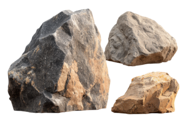 Different types of rocks placed together on a plain surface in bright light during the day