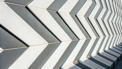 Obraz premium Angled white and gray arrow patterns create dynamic geometric design with shadows