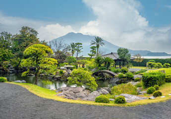 Scenic view of the historic Sengan-en Garden with the iconic Sakurajima volcano in the background, Kyushu, Japan. © Luis