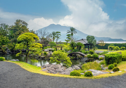 Scenic view of the historic Sengan-en Garden
with the iconic Sakurajima volcano in the background, Kyushu, Japan.