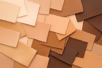 Fototapeta premium Assorted fabric swatches in diverse skin tone shades with zigzag edges arranged in an overlapping pattern on a flat background. Ai generative. Ai generative