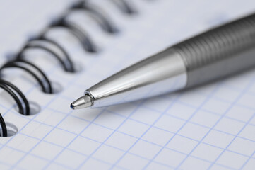 Close-up of a pen lying on a piece of paper in a diary,