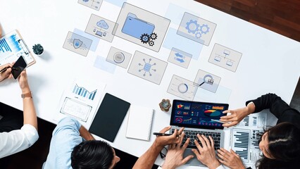 A diverse team collaborates in a modern office setting, analyzing data and discussing strategies while surrounded by digital charts and graphics for effective decision-making. Raster