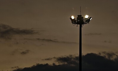Lampposts with the night sky as a backdrop.