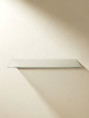 Minimalist glass shelf against a light wall
