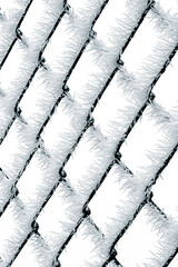 Frozen wire fence covered with sharp ice crystals creating repeating winter pattern on white background