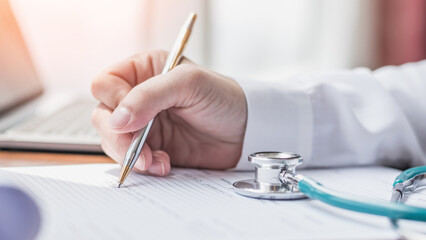 Medical equipment, stethoscope and notepad clipboard with patient discharge health record paperwork on doctor's work desk background for medic care, healthcare appointment, checkup exam or diagnosis