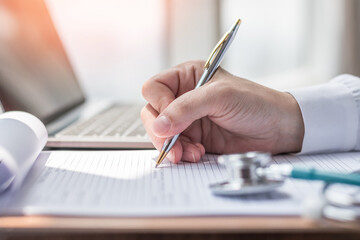 Medical equipment, stethoscope and notepad clipboard with patient discharge health record paperwork on doctor's work desk background for medic care, healthcare appointment, checkup exam or diagnosis