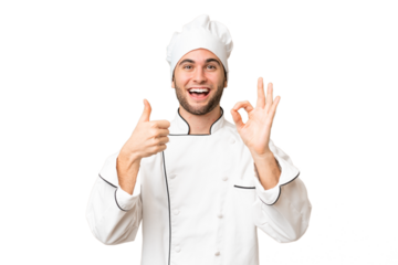 Young handsome chef man over isolated background showing ok sign and thumb up gesture