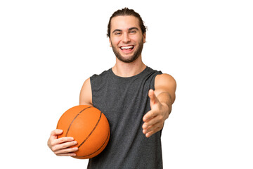 Obraz premium Young basketball player man over isolated background shaking hands for closing a good deal